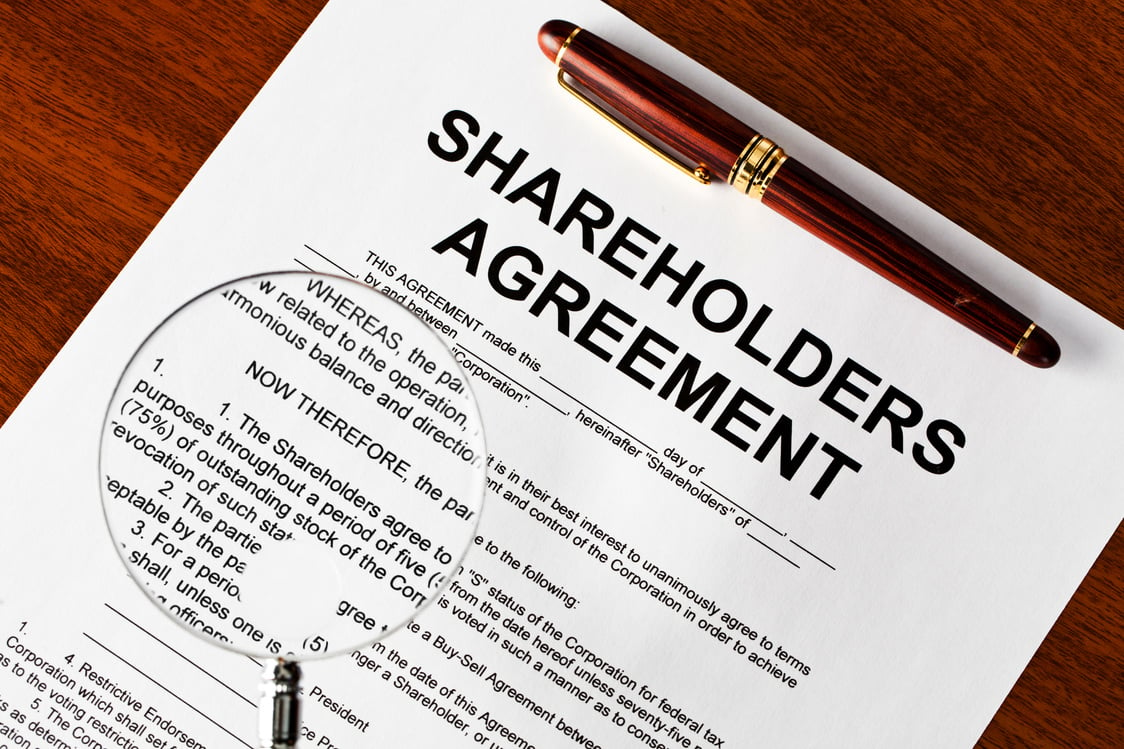 Magnifying glass on shareholders agreement